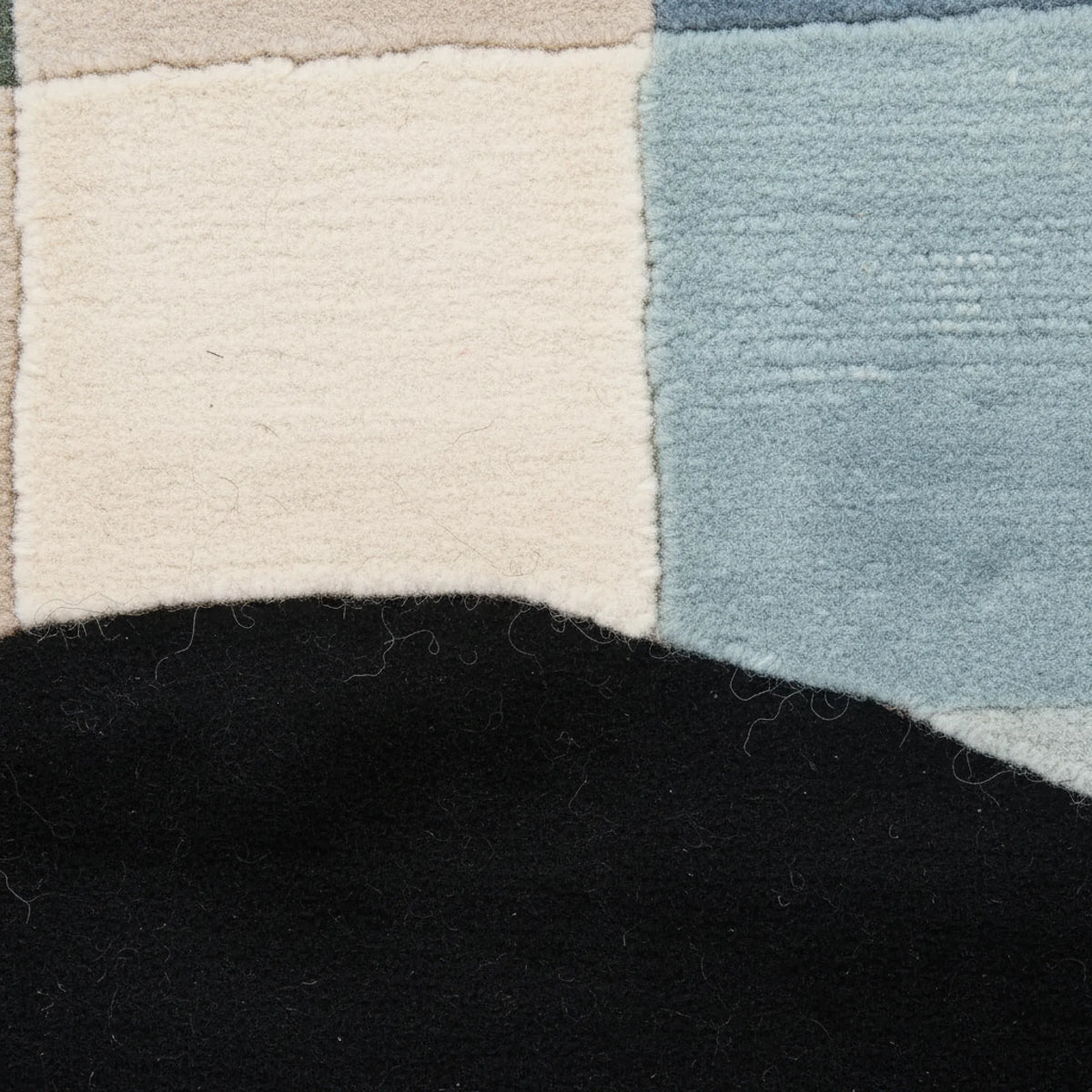 Close-up of a textured rug with geometric pattern