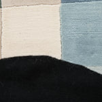 Close-up of a textured rug with geometric pattern