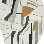 This image showcases a contemporary wool area rug featuring an abstract design with muted colors. Ideal for large living rooms, this hand-tufted rug combines tones of grey, black, and rust orange, creating a stylish and modern look perfect for any space.