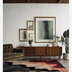 Contemporary area rug with an abstract design, featuring bold colors and wavy patterns, placed in a stylish living room setting with mid-century modern furniture and wall art. Perfect for an 8x10 living room space, this wool rug adds a touch of elegance and modern flair.