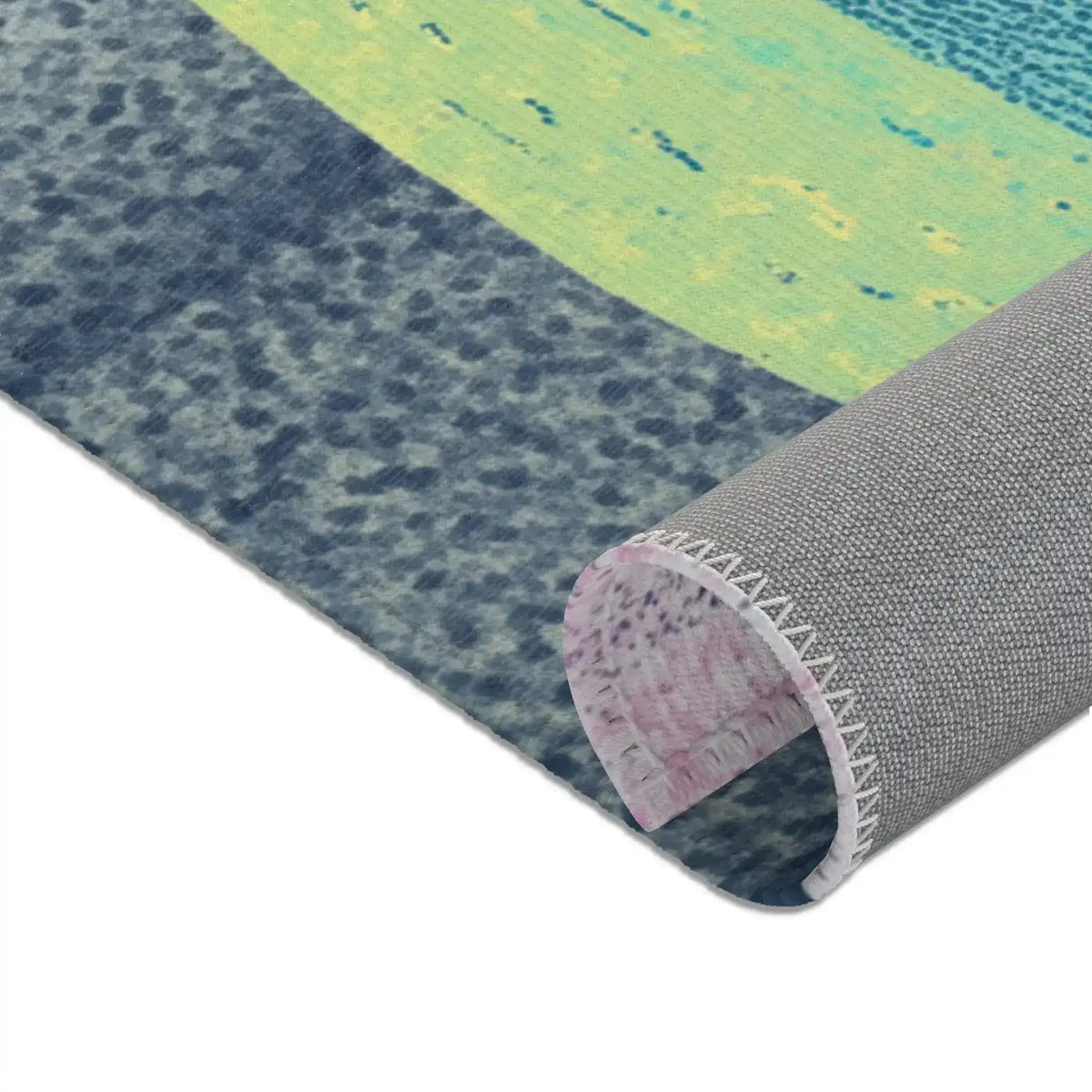 Rolled corner showing blue-grey stone base, lime-green body, and grey woven anti-slip underside, Mystic Guardian Accent Rug