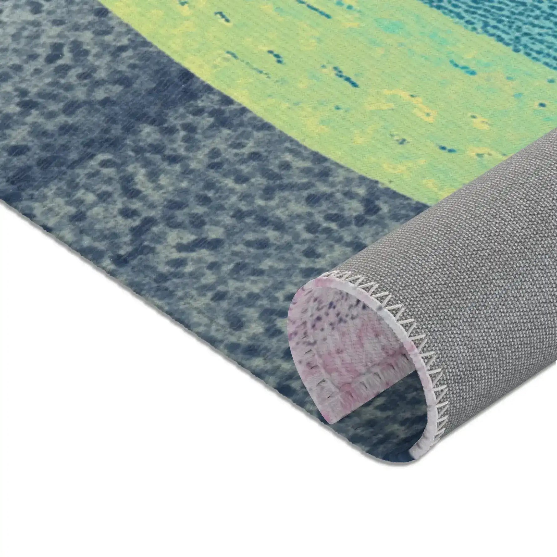 Rolled corner showing blue-grey stone base, lime-green body, and grey woven anti-slip underside, Mystic Guardian Accent Rug