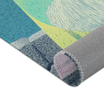 Corner fold showing teal-blue and lime body, white beard motif, grey stone base and grey backing with overlock edge, Mystic Guardian Accent Rug