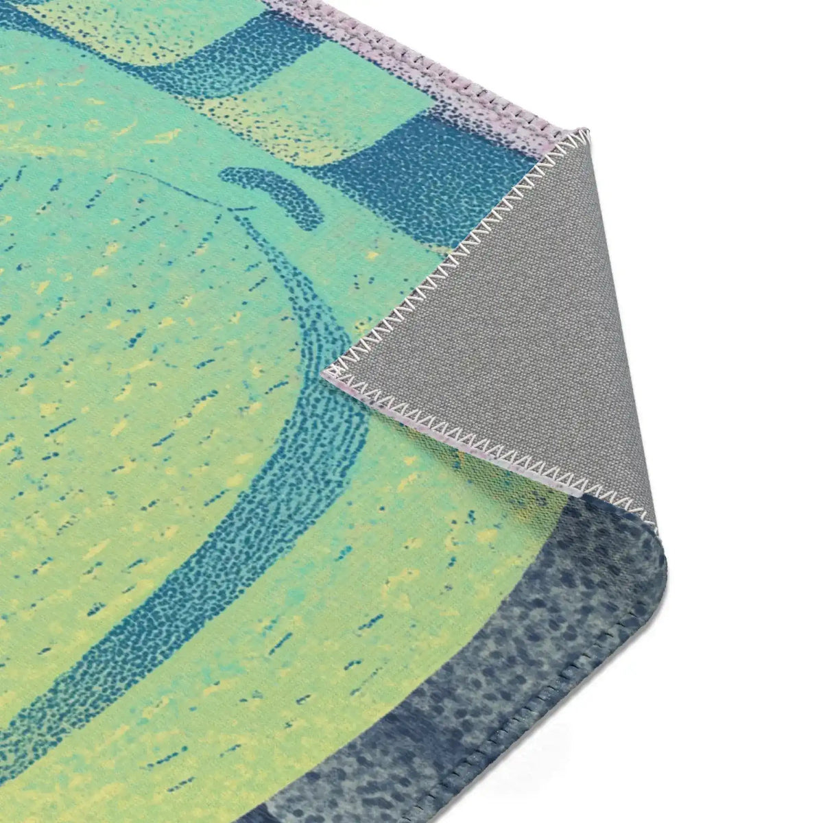 Folded corner of lime-green teal cat body print with grey non-slip backing, Mystic Guardian Accent Rug