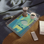 Clear acrylic Mystic Guardian Serving Tray with blue and green geometric abstract art on bedside table with moka pot and mug