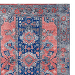 Top view of a Mystic Heritage Hand Tufted Area Rug featuring a vintage design with intricate patterns in blue, coral, and gray hues. This wool rug is perfect for adding an elegant touch to living room spaces.