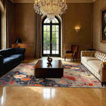 A luxurious living room featuring a Mystic Meadow Hand Knotted Area Rug, showcasing its vibrant and contemporary design. The square wool rug, adorned with colorful abstract patterns, sits elegantly beneath a wooden coffee table, complementing the classic decor. Perfect for enhancing living room or office spaces, this rug adds a touch of sophistication and warmth.