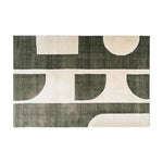 A contemporary area rug featuring an abstract geometric design in shades of dark green and cream. This wool rug adds a modern touch to any living room, perfect for those seeking stylish area rugs for living room spaces.