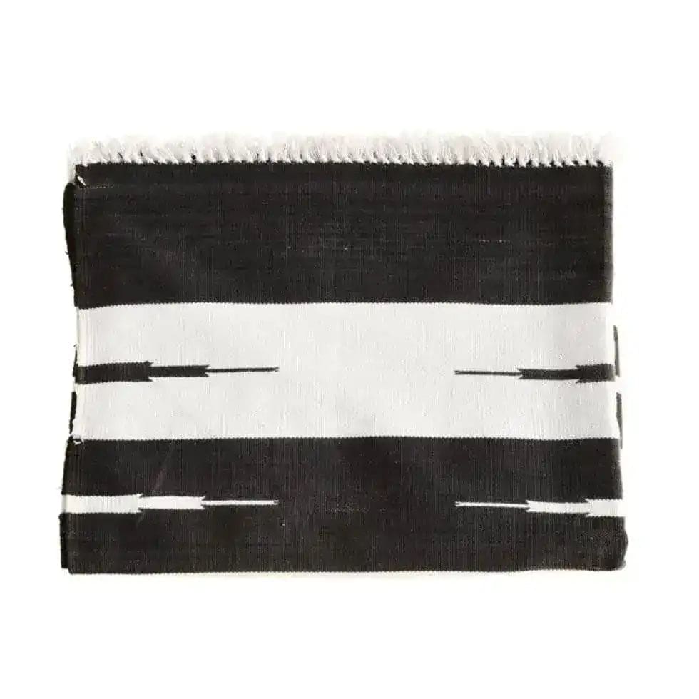 Top view of a Natural Vegetable Dyed Indian Dhurrie Reversible Cotton Area Rug in black and white. This boho rug is perfect for living rooms, especially sized 8x10, offering a stylish and versatile addition to any space.