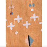 Close-up view of a Natural Vegetable Dyed Indian Dhurrie Reversible Cotton Rug in a mustard color, featuring geometric patterns. Perfect as an area rug for a dining room, this boho rug adds a touch of elegance under a dining table.