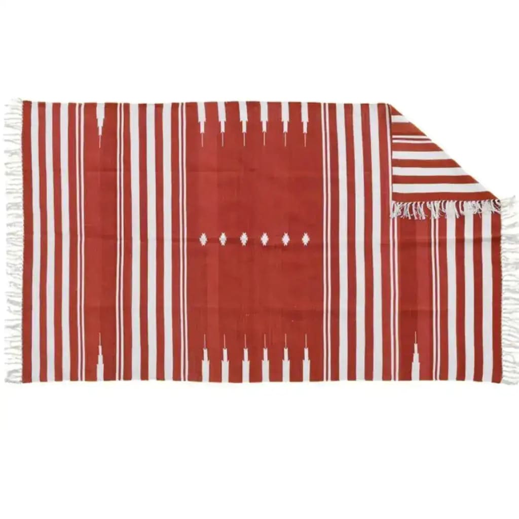 A beautiful red and white striped area rug, crafted from natural vegetable-dyed cotton, perfect for adding a boho touch to your living room or office. The reversible design of this Indian dhurrie rug makes it versatile for any space, whether you're looking for living room area rugs or office rugs.