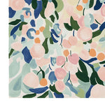 A vibrant and artistic area rug featuring a contemporary abstract floral design. This hand-tufted wool rug displays a mix of soft pinks, greens, blues, and oranges, making it an ideal choice for adding a splash of color to a living room. Perfect for those seeking a contemporary rug to enhance their home decor.