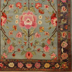 This exquisite Nature's Elegance Hand Knotted Area Rug features an intricate floral design, perfect for enhancing living room spaces. The Persian-style rug showcases vibrant pink and red blossoms against a subtle blue background, bordered by detailed floral patterns, making it an ideal choice for those seeking elegant living room area rugs.