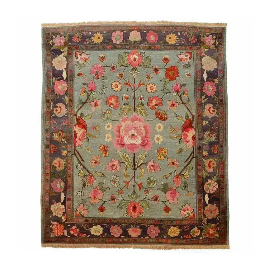 A beautifully crafted Nature's Elegance Hand Knotted Area Rug showcasing intricate floral designs with vibrant pink and red flowers on a soft blue background. This exquisite Persian rug is perfect for adding a touch of elegance to any living room, making it a standout piece among living room area rugs.