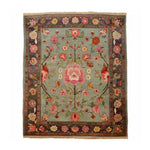A beautifully crafted Nature's Elegance Hand Knotted Area Rug showcasing intricate floral designs with vibrant pink and red flowers on a soft blue background. This exquisite Persian rug is perfect for adding a touch of elegance to any living room, making it a standout piece among living room area rugs.