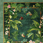 A vibrant Nature's Serenade Hand Tufted Wool Rug featuring a lush, green floral design with colorful birds. This square area rug is perfect for adding a touch of elegance to a dining room or as a centerpiece in a large living room. The intricate floral and bird patterns highlight the artistry of this wool rug, making it an ideal choice for dining room carpets or living room decor.