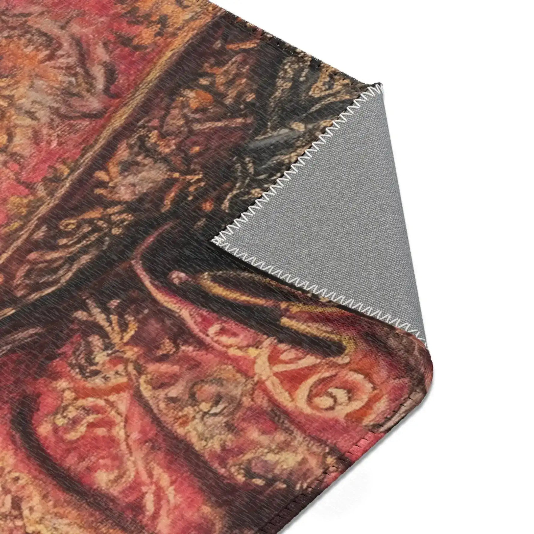 Noble Swine rug corner folded revealing red and gold ornate paisley brocade pattern on face, grey backing underneath