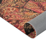 Noble Swine Opulent Pig Accent Rug corner folded back revealing grey non-slip backing, ornate red and gold brocade pattern face