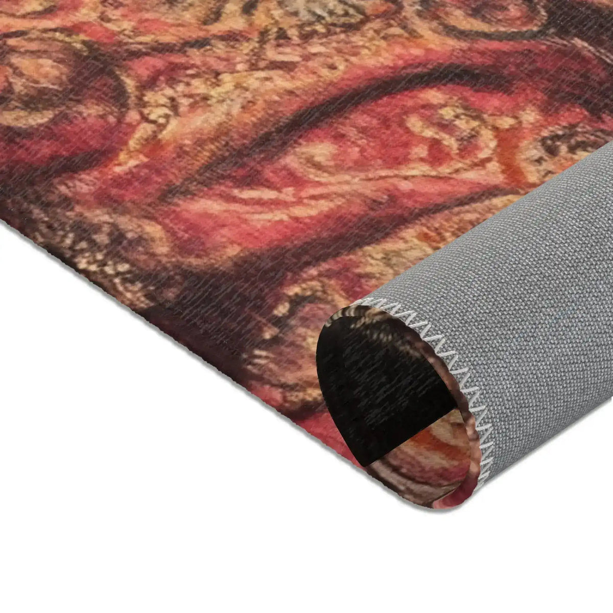 Close-up corner of Noble Swine Opulent Pig Accent Rug with curling red and gold ornate floral motif, grey anti-slip backing