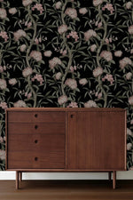 Dark Nocturnal Blushing Blossoms wallpaper behind mid-century walnut sideboard with four drawers and cabinet door