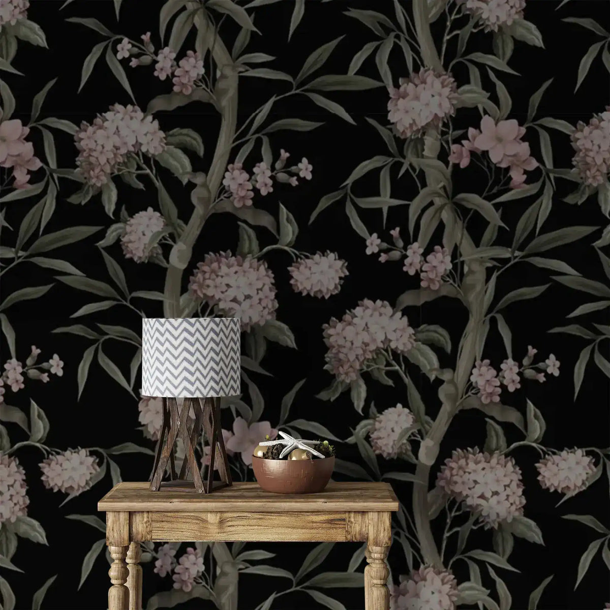 Close-up of Blushing Blossoms wallpaper, black ground with pink clustered blooms and green stems, lamp and console below