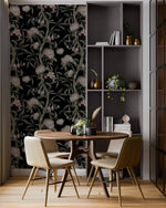 Nocturnal Blushing Blossoms wallpaper in dining room, black background with pink flowers and green stems, round wood table