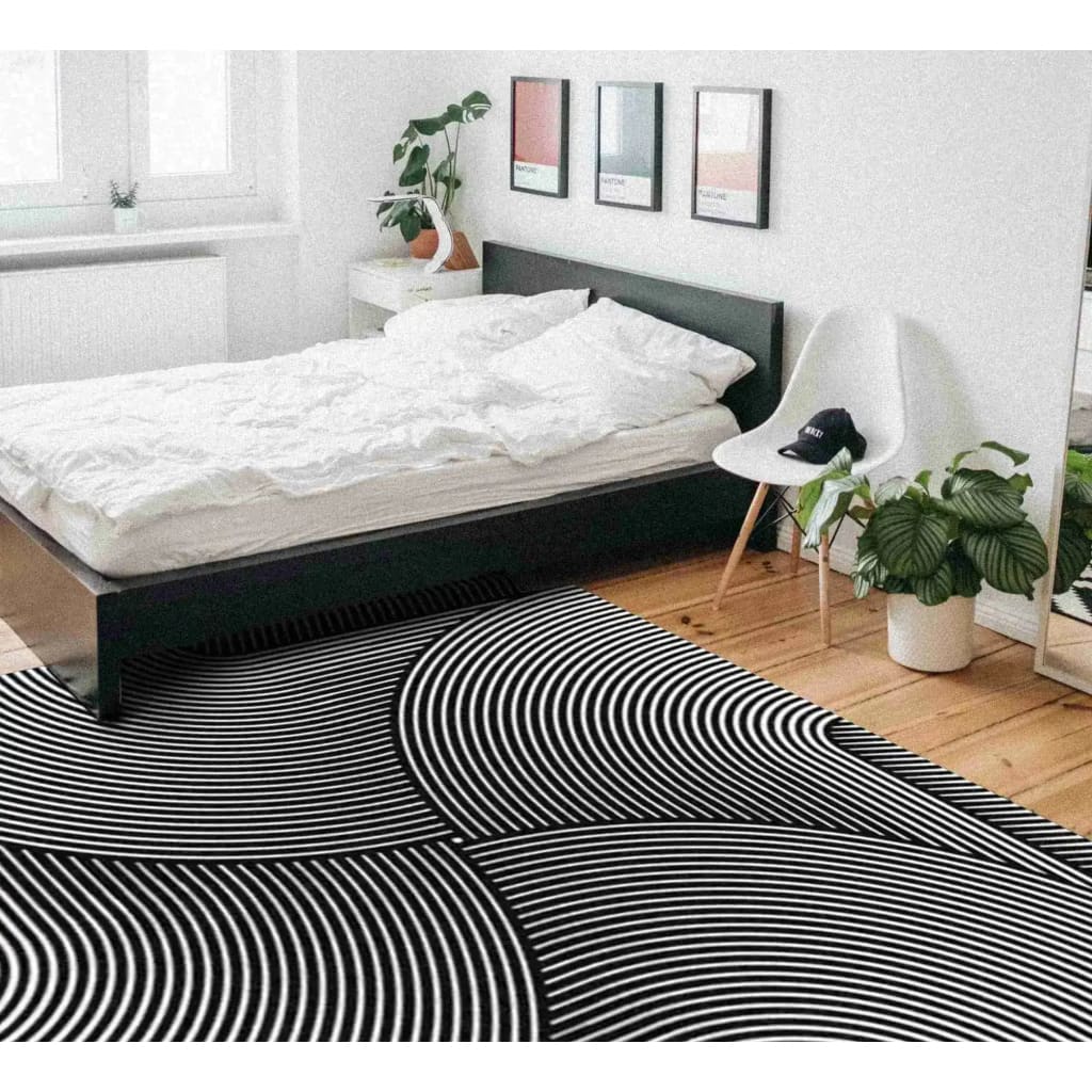 A contemporary Noir Horizon Illusion Square Hand Tufted Wool Rug adding a touch of elegance to a modern bedroom. This square area rug features a striking black and white geometric pattern, perfect for enhancing living room spaces with its large size and cozy wool texture.
