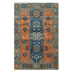 A beautifully crafted Nomadic Heritage Knotted Wool Rug featuring vibrant orange and blue patterns with intricate floral designs. This vintage area rug is perfect for enhancing the decor of dining rooms, bedrooms, and living rooms.