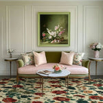 A cozy living room setting featuring a Nostalgic Poppy Haven Hand Tufted Wool Rug with a vibrant floral design. This large square area rug, perfect for a dining room or living room, complements the elegant sofa and decor. Ideal for 8x10 living room spaces, this wool rug adds a nostalgic touch with its colorful poppy pattern.