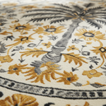 Close-up of a floral patterned rug with yellow and gray colors.