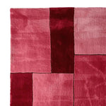 Top view of the Obscura Red Panel Hand Tufted Area Rug, showcasing its bold geometric design in shades of red. This contemporary wool rug adds a vibrant touch to any living room, offering a modern aesthetic that's perfect for contemporary decor.