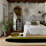 Stylish area rug in a modern bedroom setting, featuring a hand-tufted design with bold abstract shapes in earthy tones. Ideal for dining room or living room, this contemporary wool rug adds a touch of elegance to formal dining room spaces.