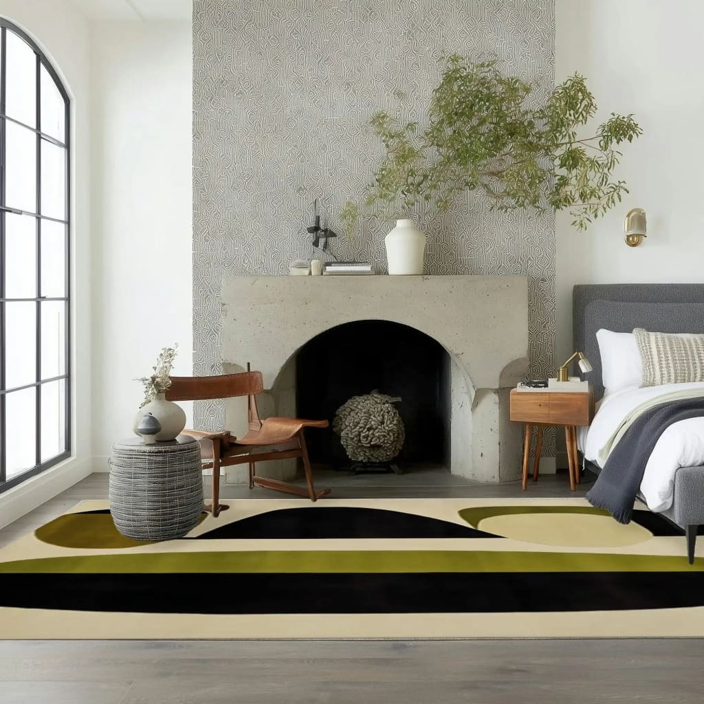 A contemporary area rug with an abstract design featuring earthy tones of black, green, and beige, placed in a modern dining room setting. The wool rug complements the minimalist decor, with a stylish chair and side table near a sleek fireplace, making it perfect for formal dining rooms and living room spaces.