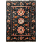 A luxurious Obsidian Floral Frame Hand Knotted Area Rug in a rich black hue, featuring intricate floral patterns in warm tones. This wool rug is perfect for adding elegance to living rooms, especially in the 8x10 size.