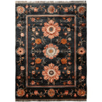 A luxurious Obsidian Floral Frame Hand Knotted Area Rug in a rich black hue, featuring intricate floral patterns in warm tones. This wool rug is perfect for adding elegance to living rooms, especially in the 8x10 size.