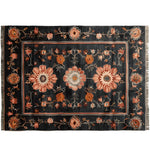 A beautifully crafted area rug featuring a striking floral pattern in warm hues on a dark background. This wool rug, perfect for adding elegance to any living room, measures 8x10 feet, showcasing intricate hand-knotted details.
