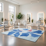 Modern salon interior with white chairs, a blue abstract rug, and large mirrors.