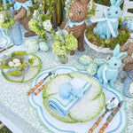 ocean breeze placemats with blue scalloped border and leaf print in a spring tablescape with cabbage plates and Easter bunny decor