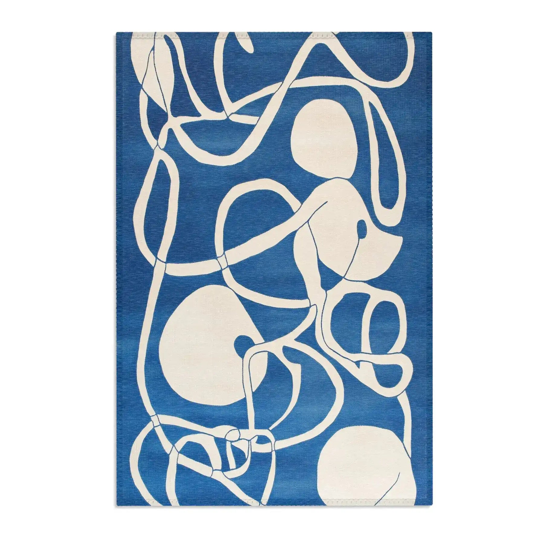 Bold cobalt blue Ocean Flow Abstract Blue and White Rug with swirling cream line drawings and organic blob shapes, flat lay