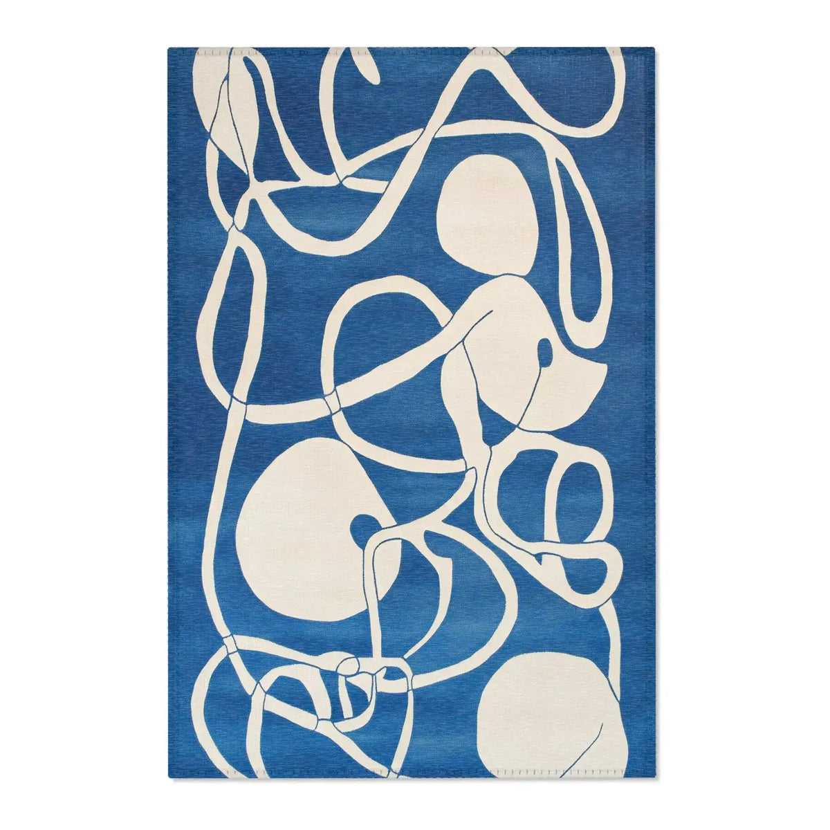 Ocean Flow rug flat lay featuring whimsical crocodile in aristocratic ruffled jacket and red round sunglasses on grey background