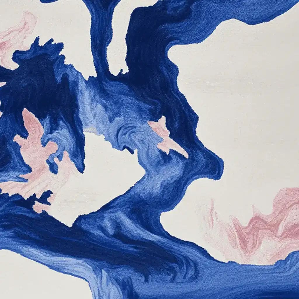 The Ocean Vein Hand Tufted Rug is a captivating area rug featuring a swirling abstract design in deep blue and soft pink hues against a cream background. This contemporary wool rug offers a modern touch, perfect for enhancing living room spaces. Ideal for those seeking stylish area rugs for living rooms.