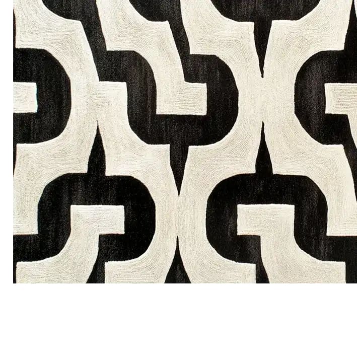 A contemporary wool area rug with a bold black and white geometric pattern, perfect for enhancing modern living room spaces. This hand-tufted rug adds a touch of sophistication to any living room area.