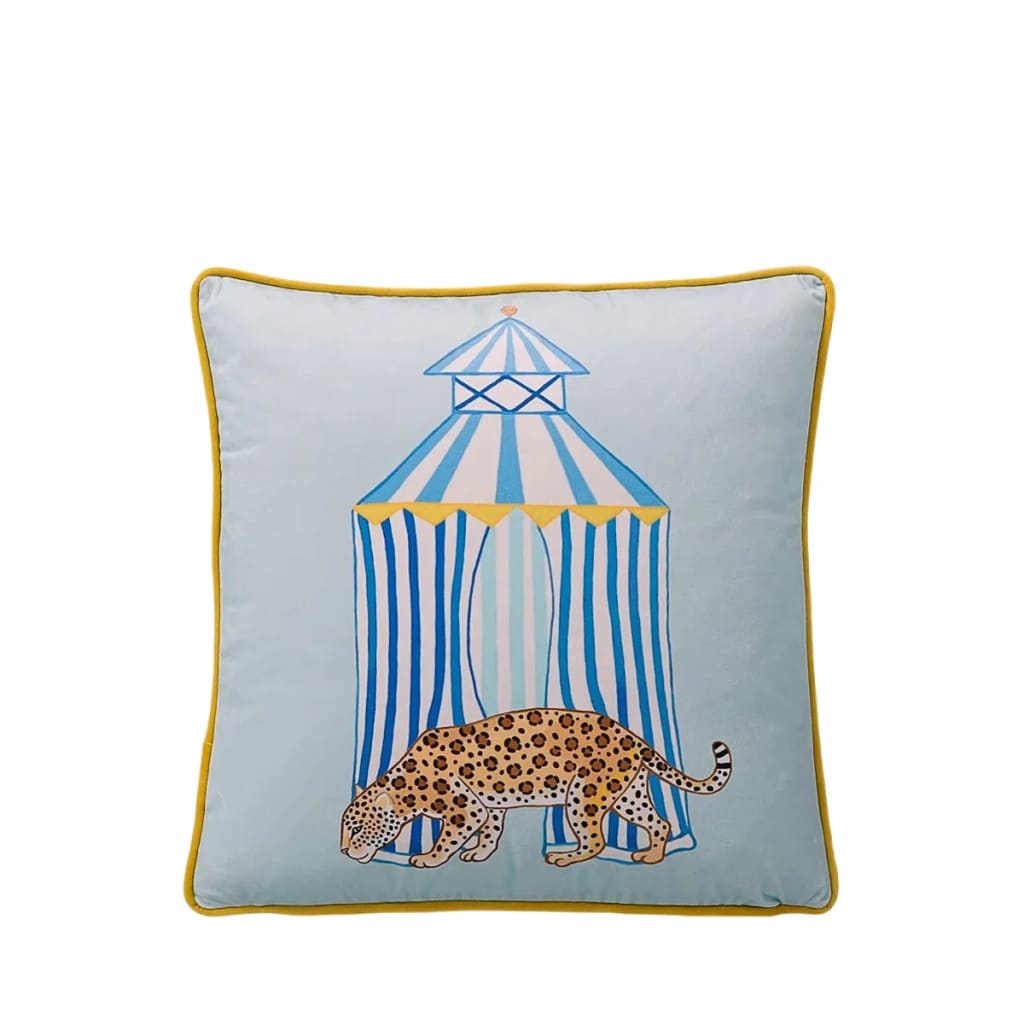 Opulent coastal leopard throw pillow featuring a playful leopard design in front of a striped tent, perfect for adding a touch of elegance to any living space.