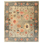 Beautifully designed Opulent Legacy Hand Tufted Wool Rug, ideal for living rooms. This area rug features intricate floral patterns in warm tones on a neutral background, perfect for large living room spaces.