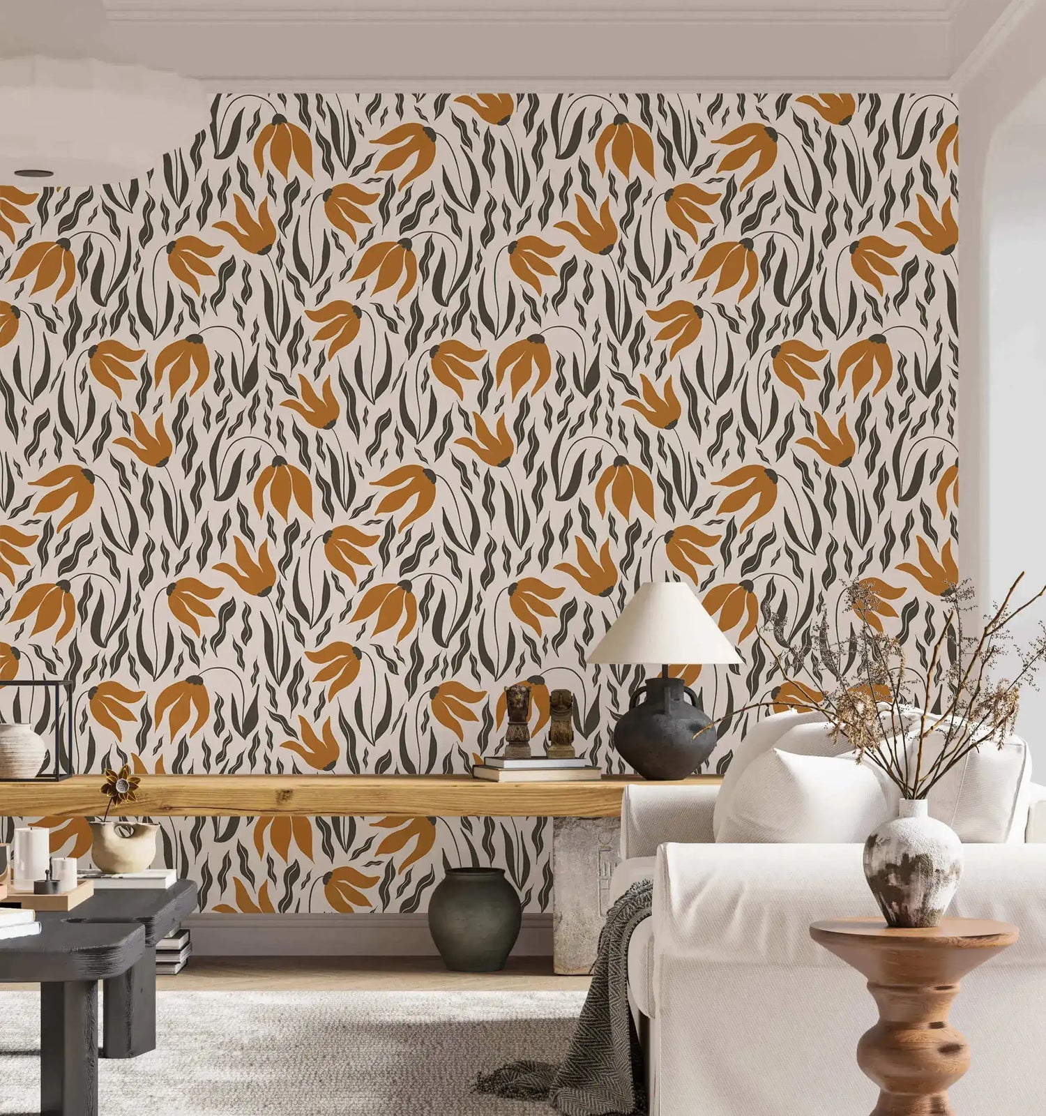 Orange Blossom Symphony Wallpaper of amber leaf motifs and dark gray strokes on beige behind white sofa and oak console.