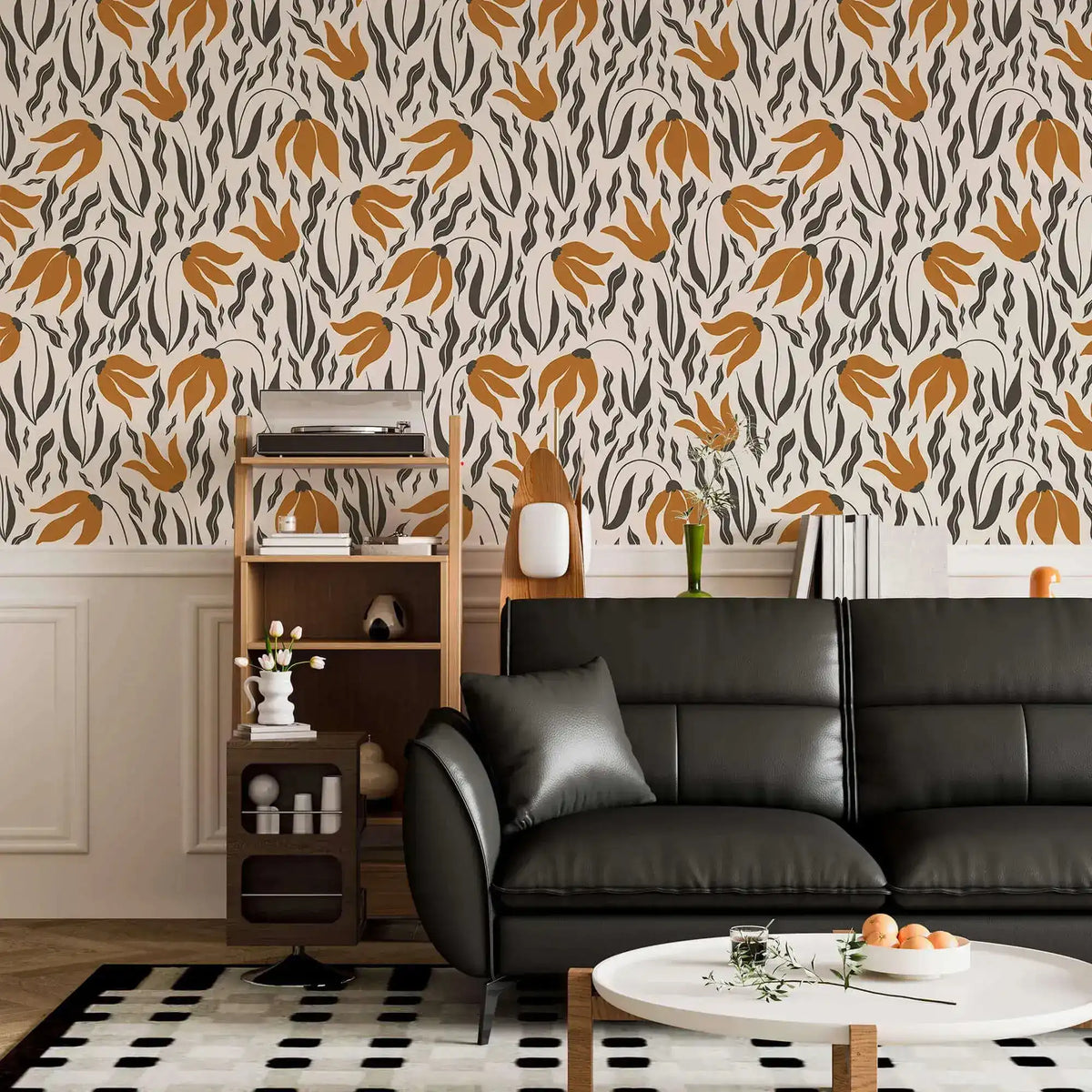 Orange Blossom Symphony Wallpaper with burnt orange blossoms and charcoal grass above chair rail, black leather sofa.