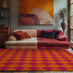 A vibrant area rug with orange and pink clover patterns enhances the cozy ambiance of a living room. The wool rug, perfect for both dining room and living room settings, measures 8x10 and complements the colorful sofa and abstract wall art.