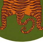 Close-up view of an Orange Tibetan Tiger Green Hand Tufted Round Rug, showcasing vibrant tiger stripes on a green background. This wool rug is a perfect large area rug for an office or living room, adding a bold and exotic touch to any space.