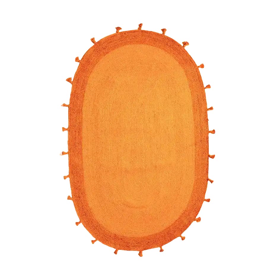 Vibrant orange two-toned oval jute area rug with tassels, perfect for adding a bohemian touch to a bedroom. This large area rug is ideal for those looking for stylish rugs for the bedroom.
