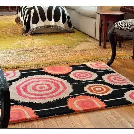 A vibrant area rug with abstract circular patterns in pink, orange, and black, perfect for adding a pop of color to your living room or dining room. This wool rug serves as a stunning vintage rug option for living room rugs 8x10, blending seamlessly with modern and eclectic decor.